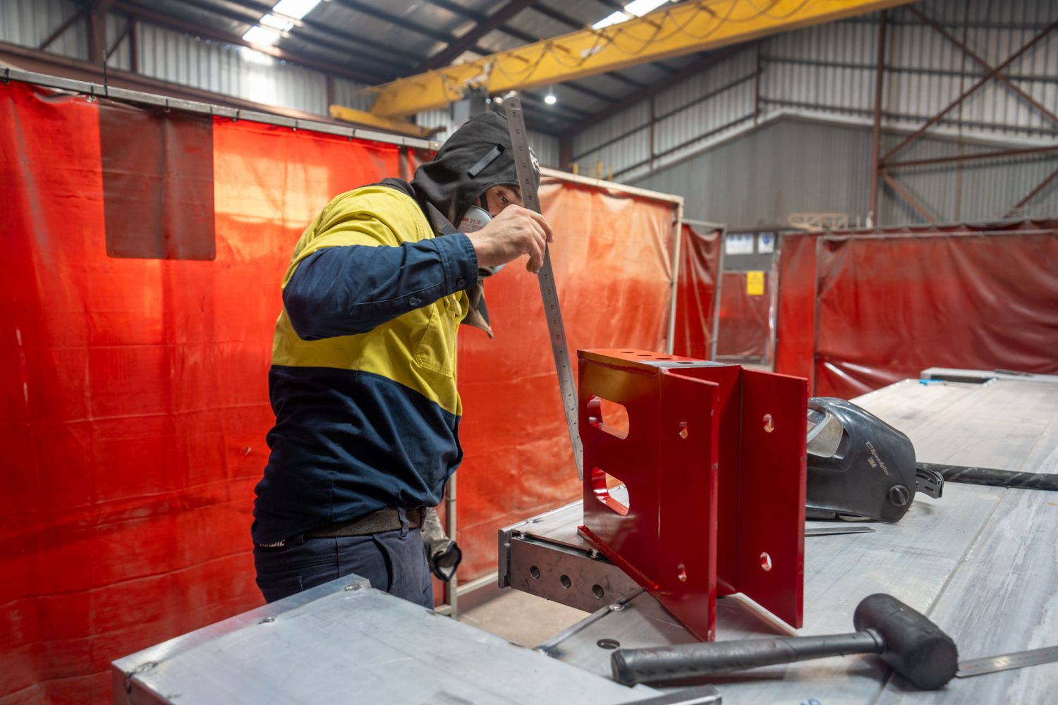 A manufacturing team member measuring a panel connector